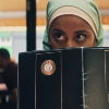 amina peeking over her menu